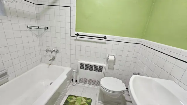 a bathroom with a toilet and a bathtub