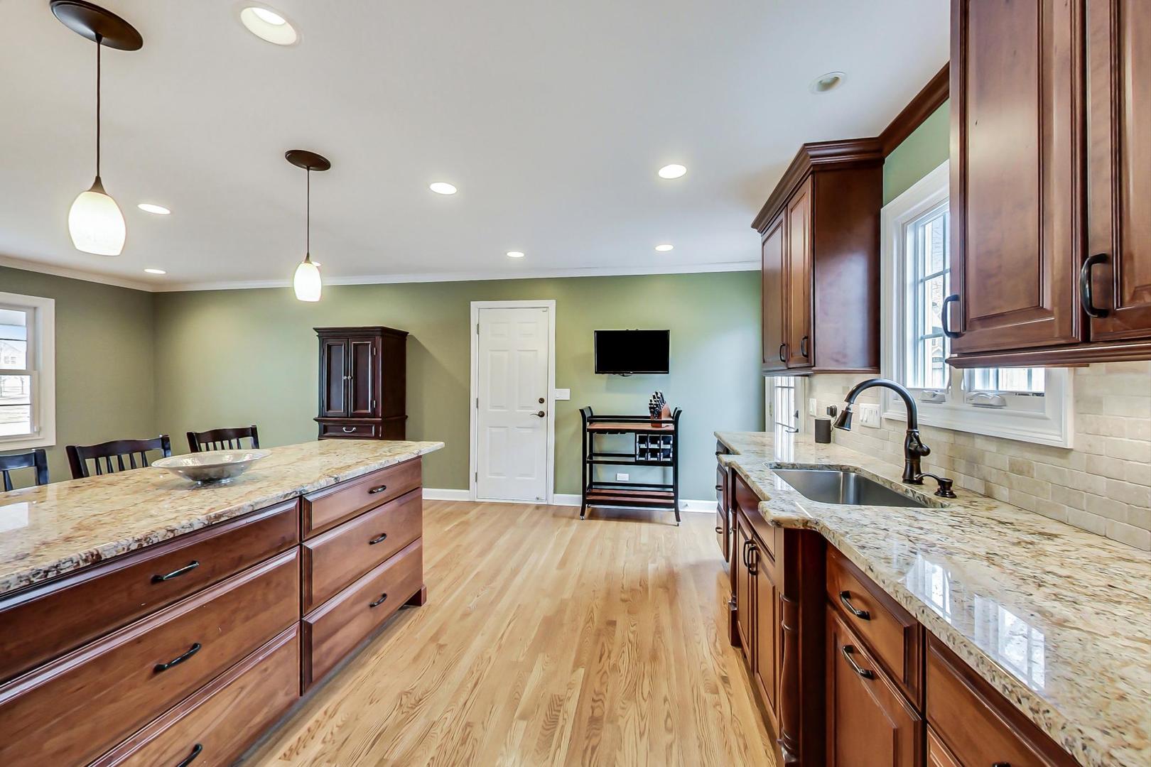 N369 Calvin Court Winfield, IL 60190 - Photo 11 of 41 a kitchen with granite countertop a sink a counter top space appliances and cabinets