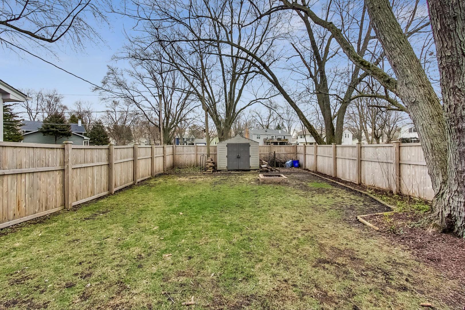 N369 Calvin Court Winfield, IL 60190 - Photo 35 of 41 a view of backyard with tree and wooden fence
