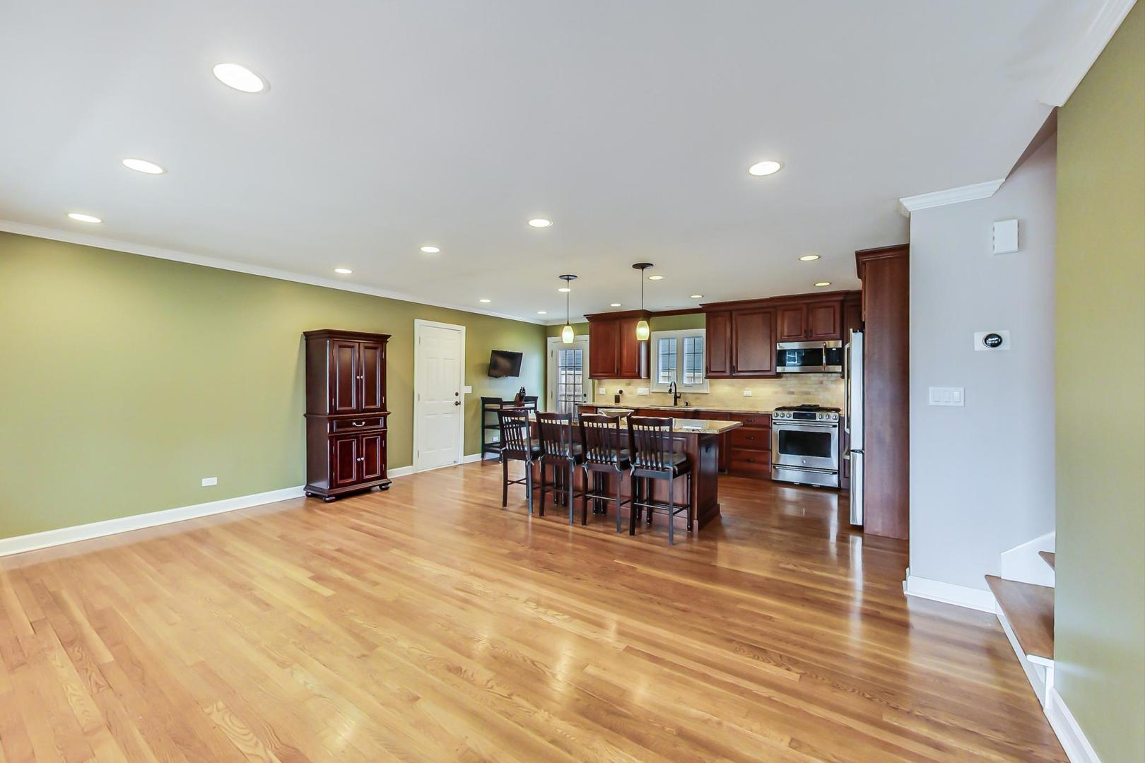 N369 Calvin Court Winfield, IL 60190 - Photo 6 of 41 a view of a kitchen with dining room and wooden floor