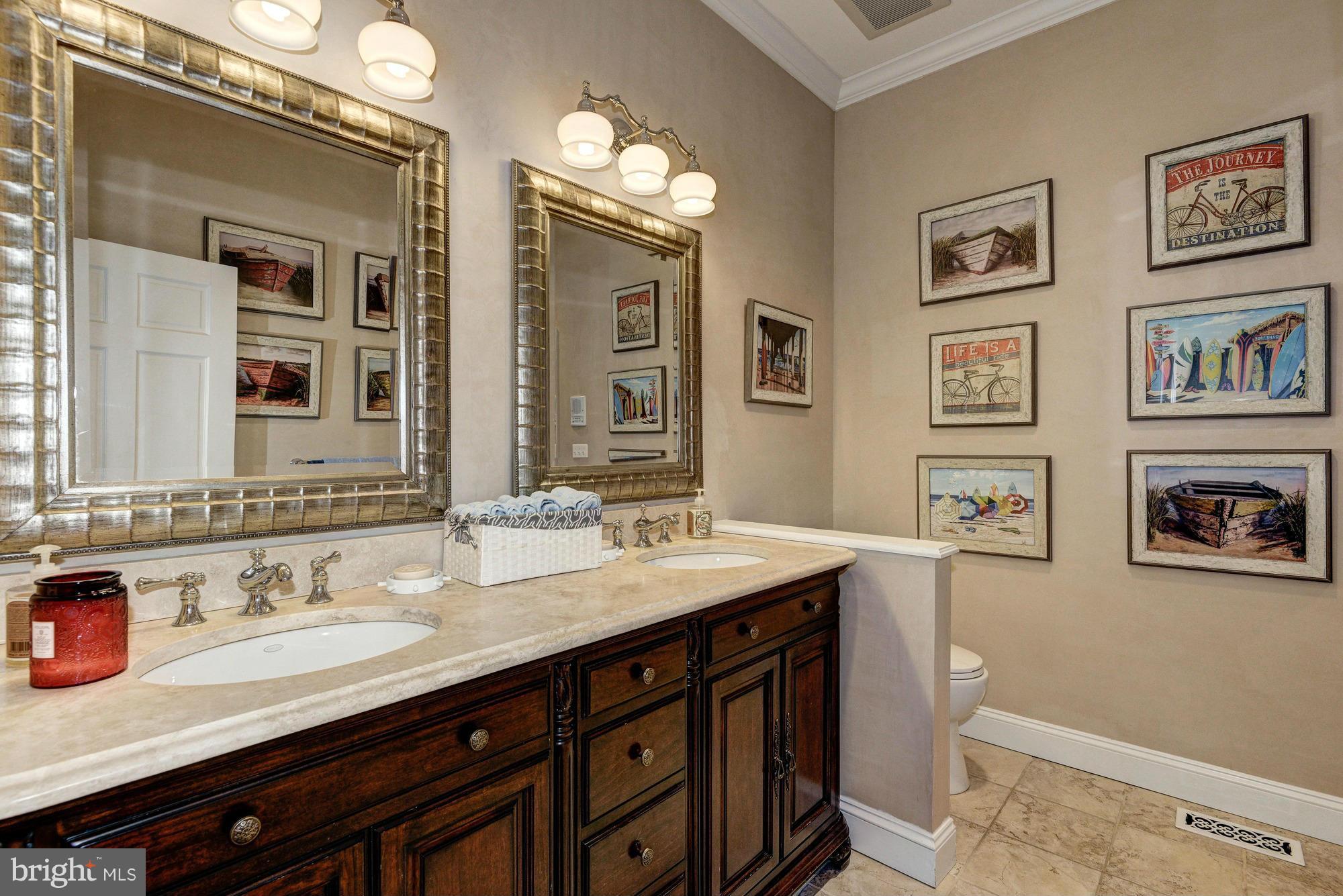 532 Sunset Road Annapolis, MD 21403 - Photo 18 of 30 a bathroom with double vanity sinks a vanity a lamp and a mirror