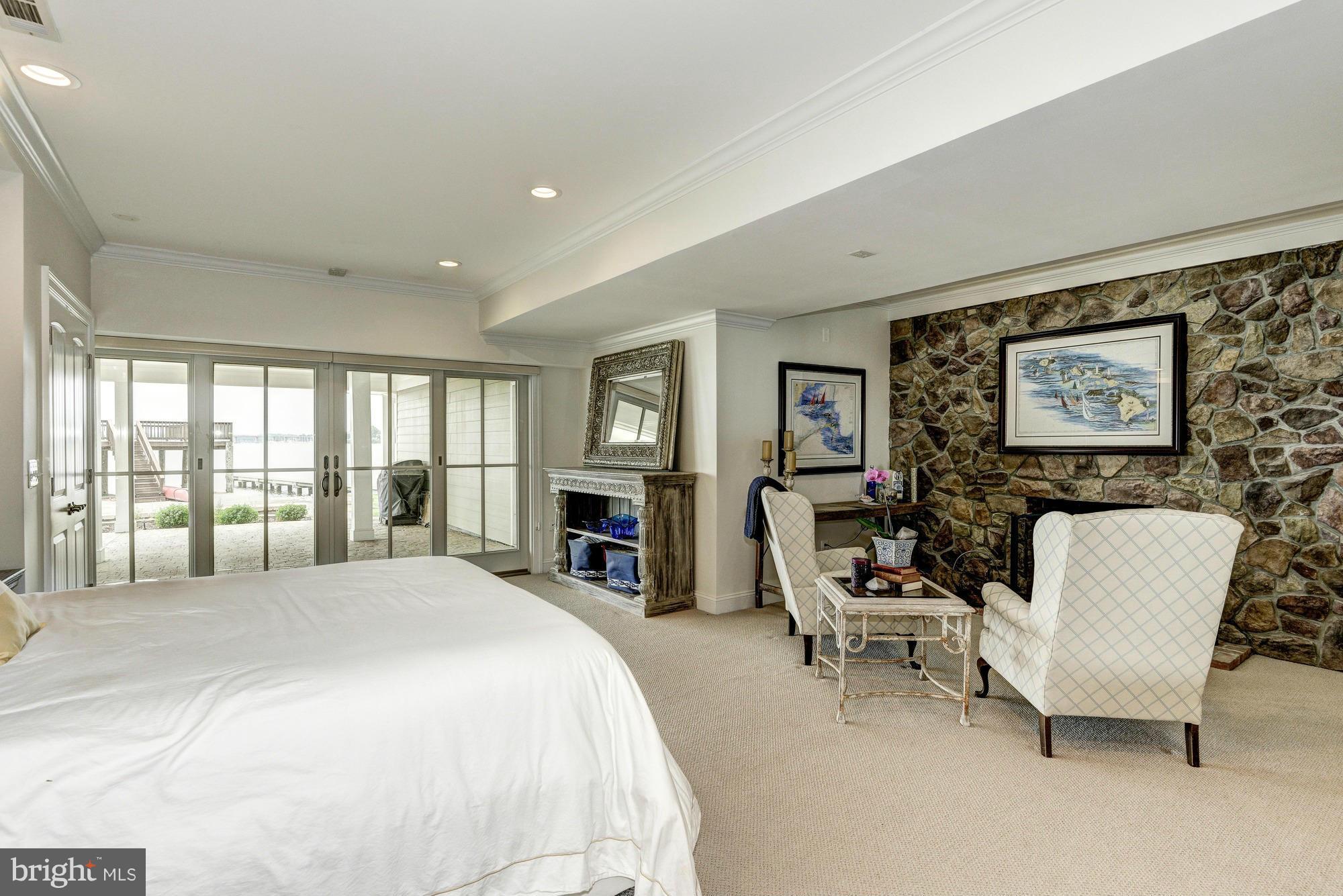 532 Sunset Road Annapolis, MD 21403 - Photo 19 of 30 a spacious bedroom with a bed a couch and large windows