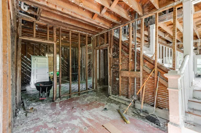a view of a house with a door and wooden deck