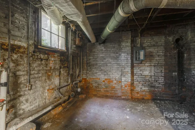 a view of a house with a big yard and large trees