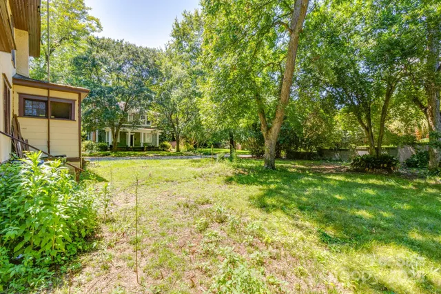 a view of a house with a tree in the background