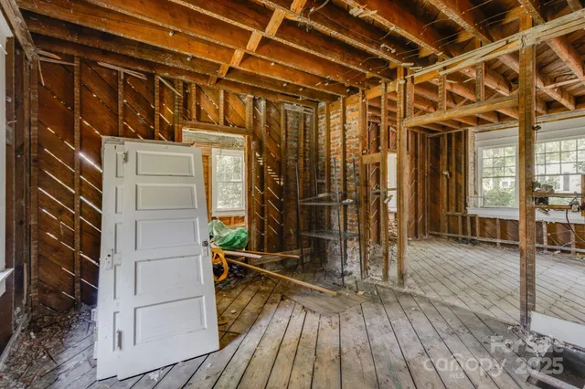 a view of a room with wooden floor