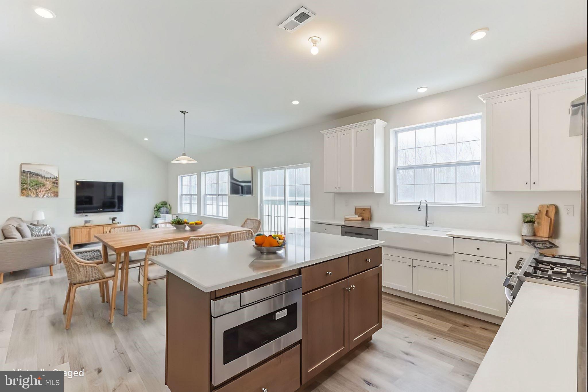 35 Barbertown Point Breeze Road Frenchtown, NJ 08825 - Photo 11 of 43 a kitchen with stainless steel appliances a stove a sink a refrigerator and white cabinets with wooden floor