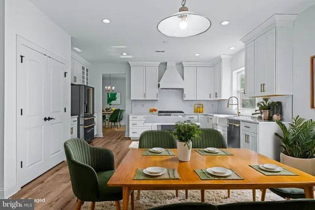 a dining room with furniture a window and wooden floor