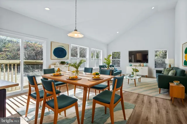 a living room with furniture fireplace and a large window