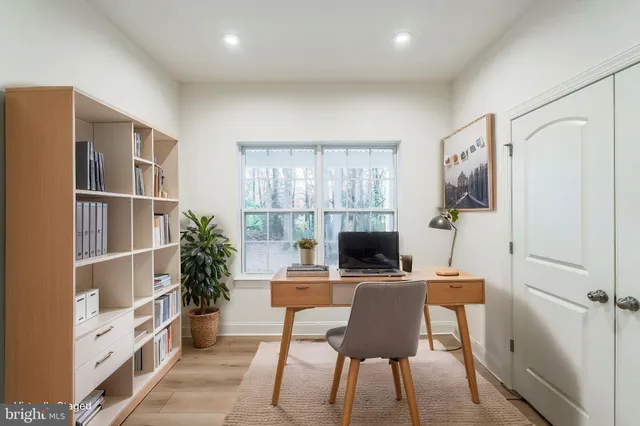 a bedroom with a large bed a flat screen tv and a couch