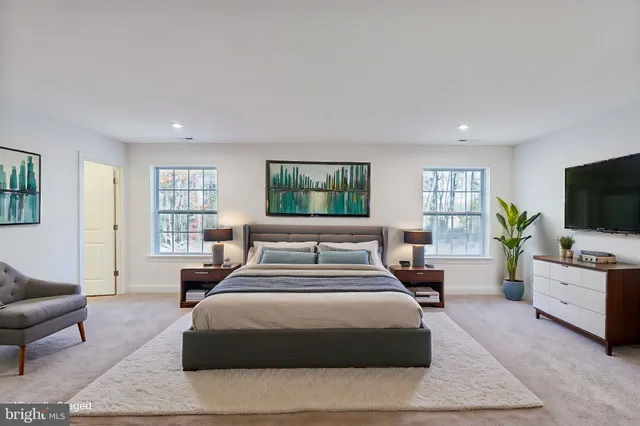 a bedroom with a bed and a potted plant