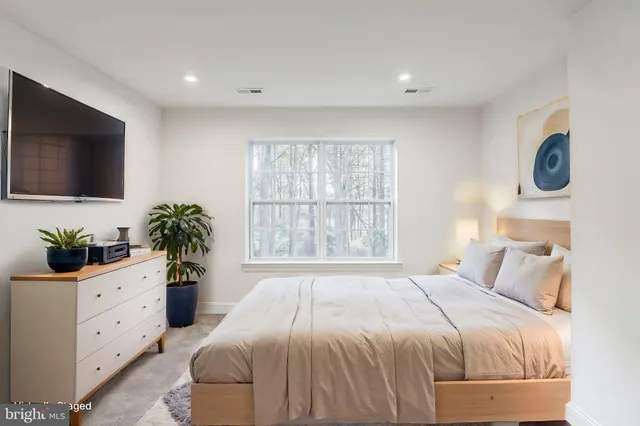 a bedroom with a bed and a couch