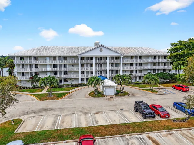 a view of a house with swimming pool and sitting area