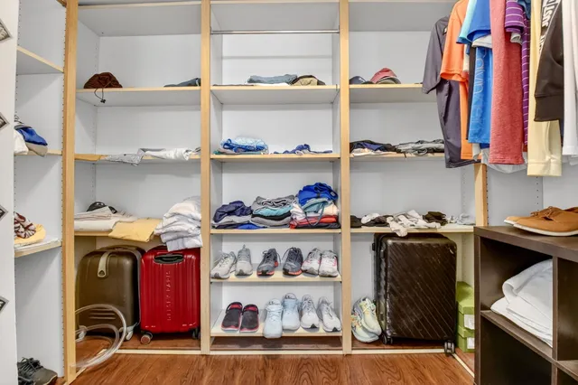 a view of a lake with a yard and large trees