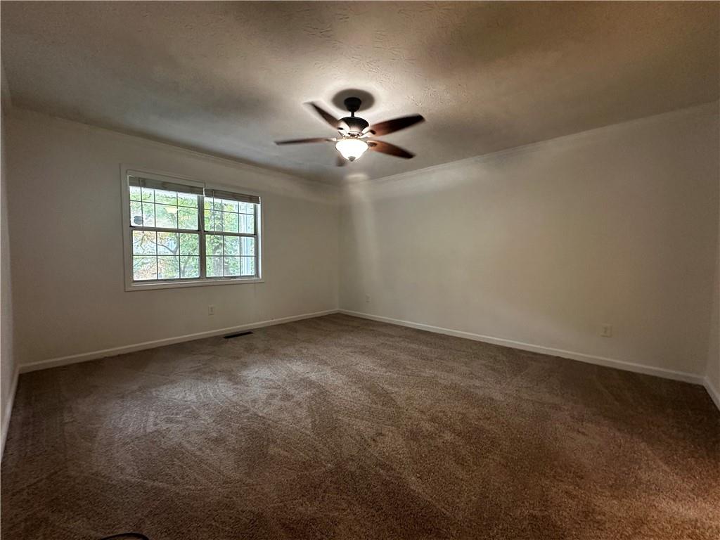 2536 Country Lake Circle Powder Springs, GA 30127 - Photo 13 of 25 an empty room with fan and windows