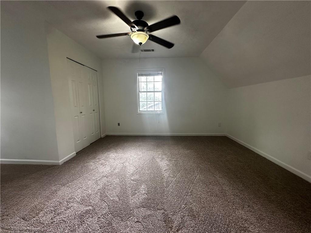 2536 Country Lake Circle Powder Springs, GA 30127 - Photo 18 of 25 an empty room with a window and a fan