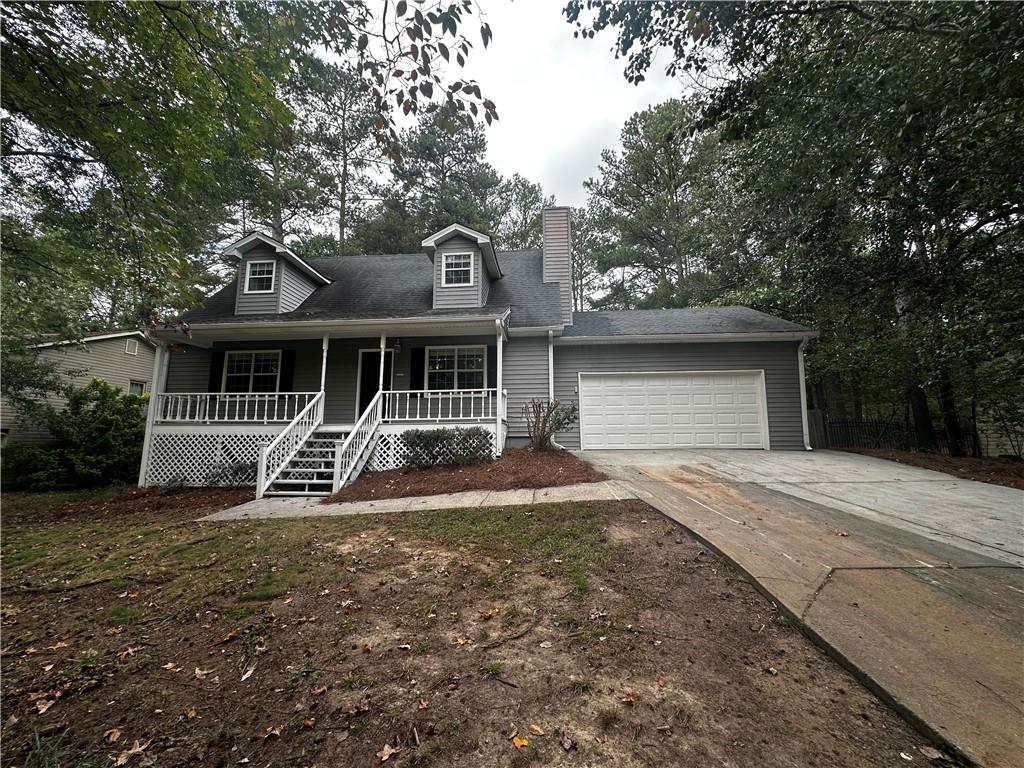 2536 Country Lake Circle Powder Springs, GA 30127 - Photo 2 of 25 a front view of a house with a yard and garage