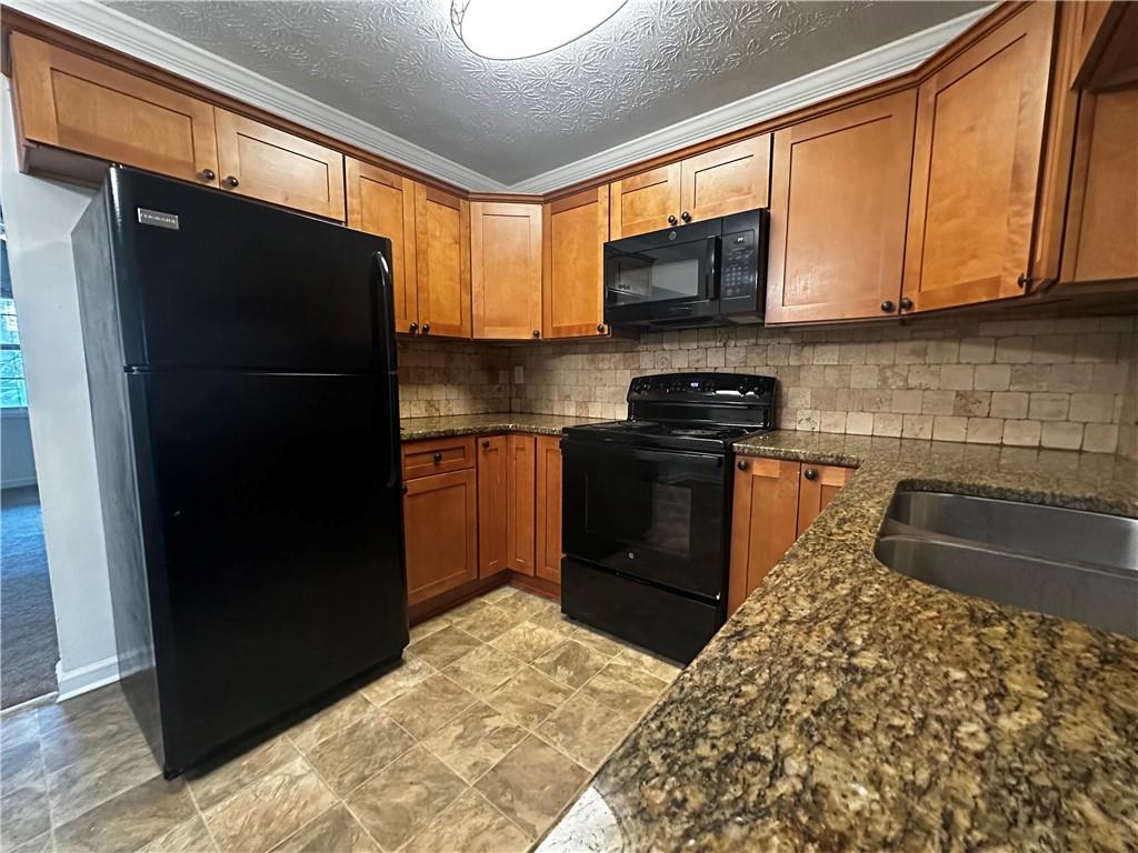 2536 Country Lake Circle Powder Springs, GA 30127 - Photo 10 of 25 a kitchen with stainless steel appliances granite countertop a refrigerator and a sink