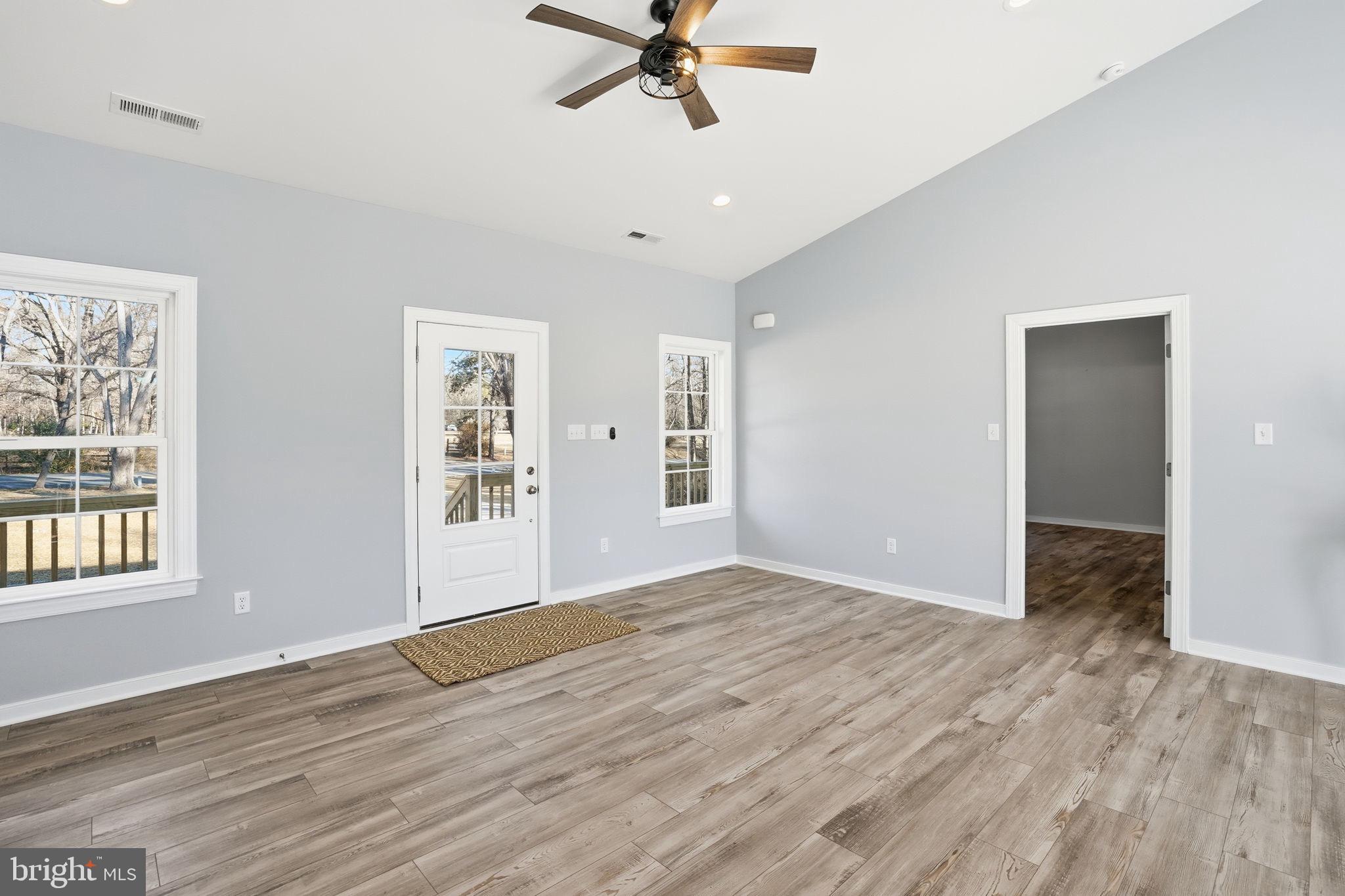 475 Fredericks Hall Road Bumpass, VA 23024 - Photo 13 of 44 a view of an empty room with window and wooden floor