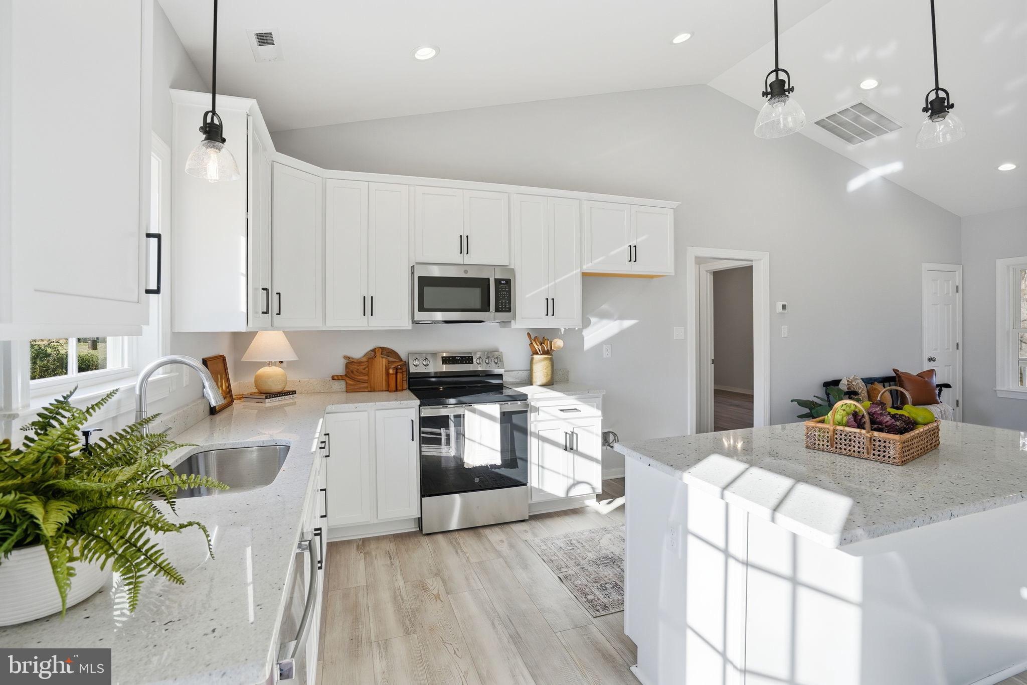 475 Fredericks Hall Road Bumpass, VA 23024 - Photo 16 of 44 a kitchen with white cabinets and appliances