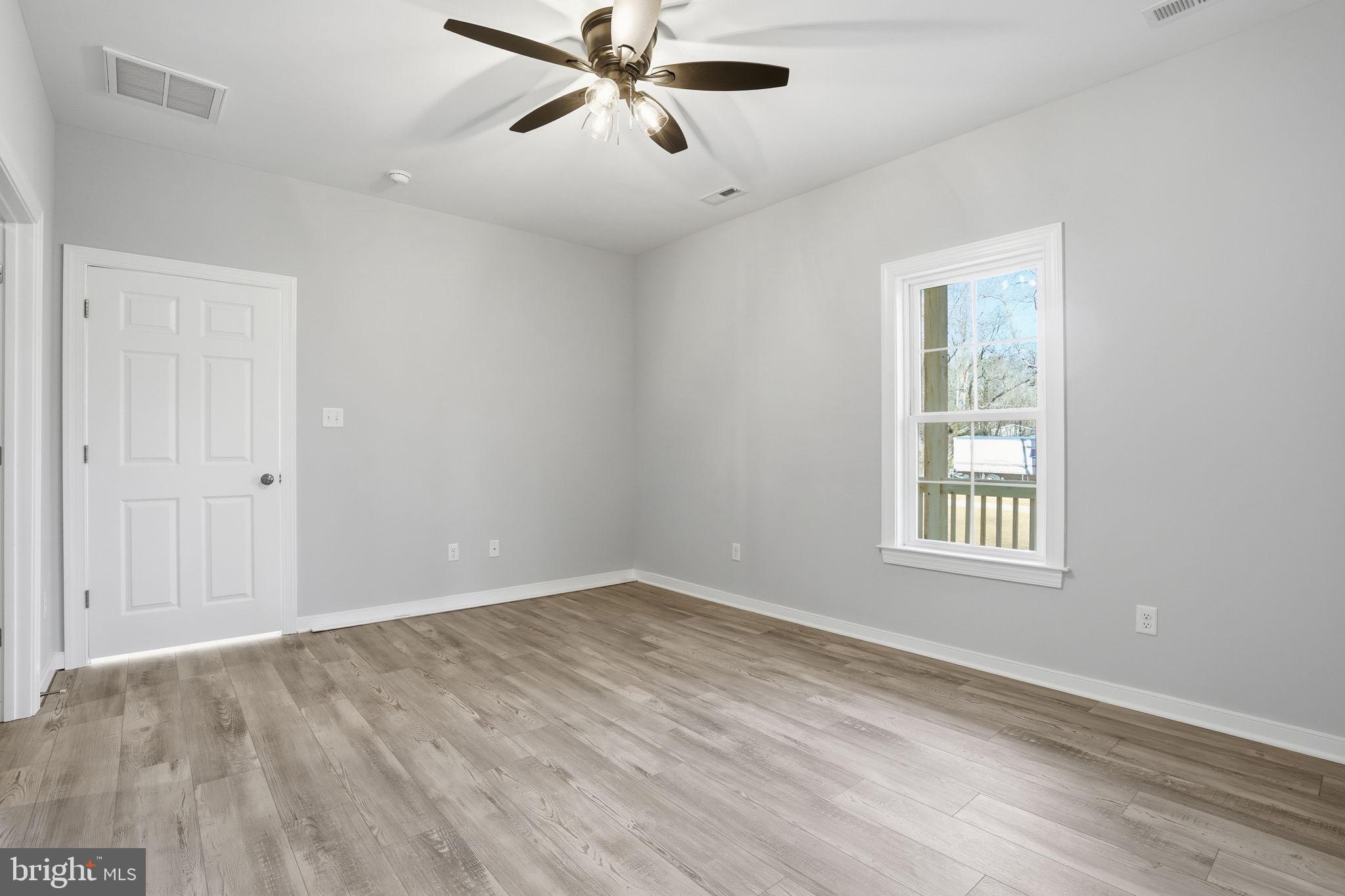 475 Fredericks Hall Road Bumpass, VA 23024 - Photo 27 of 44 wooden floor in an empty room with a window