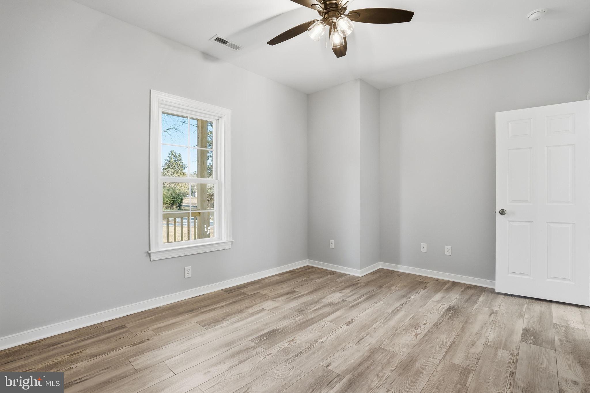 475 Fredericks Hall Road Bumpass, VA 23024 - Photo 29 of 44 wooden floor in an empty room with a window