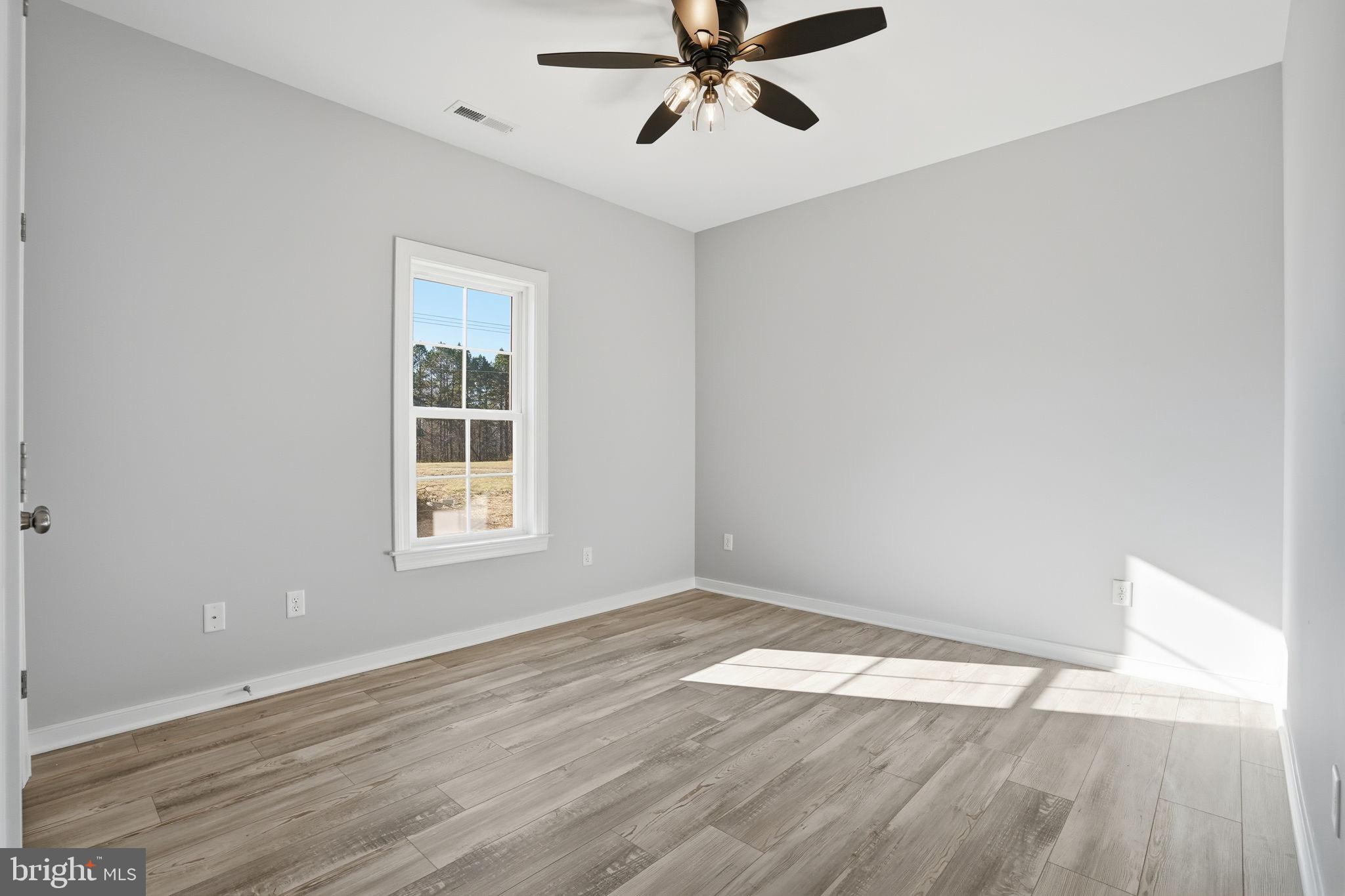 475 Fredericks Hall Road Bumpass, VA 23024 - Photo 30 of 44 wooden floor in an empty room with a window
