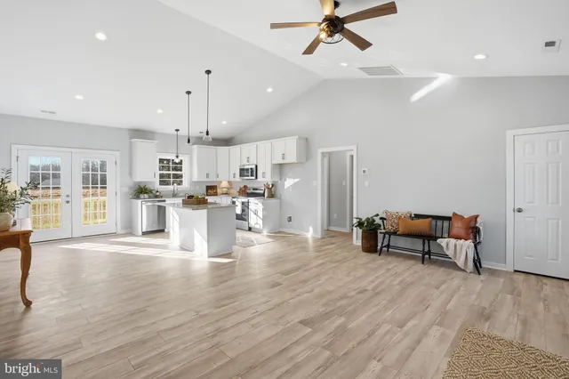 a living room with furniture and kitchen view