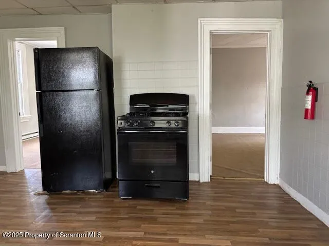 a kitchen with a refrigerator and a stove