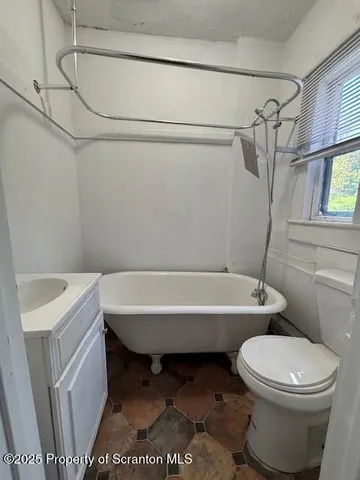 a bathroom with a toilet and a bathtub