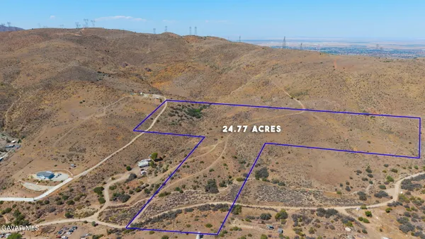 a view of a dry yard with mountain