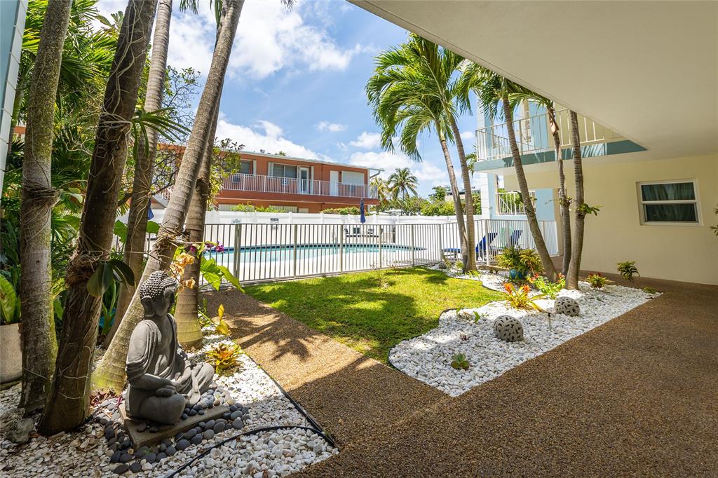 3216 Southeast 8th Street, Unit 303 Pompano Beach, FL 33062 - Photo 27 of 54 a view of a house with backyard and sitting area