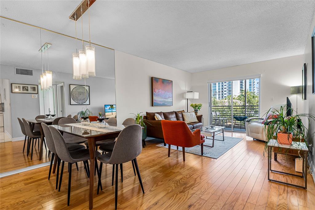 3216 Southeast 8th Street, Unit 303 Pompano Beach, FL 33062 - Photo 3 of 54 a living room with furniture and wooden floor
