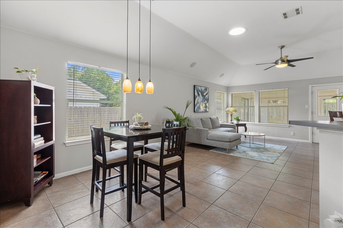9012 Meacham Way Austin, TX 78749 - Photo 13 of 34 Open-concept living space featuring vaulted ceilings, tile flooring, and multiple windows