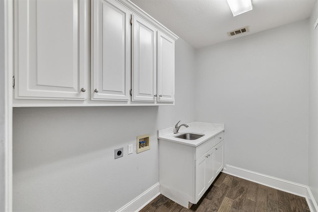 4512 Banyon Lane Dallas, TX 75287 - Photo 22 of 40 4512 Banyan Ln-Large laundry room with utility sink by Fang Underhill.