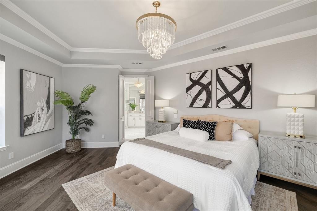 4512 Banyon Lane Dallas, TX 75287 - Photo 23 of 40 4512 Banyan Ln-Spacious primary suite designed as a private escape, highlighted by tiered ceilings and an expansive bay of windows by Fang Underhill.