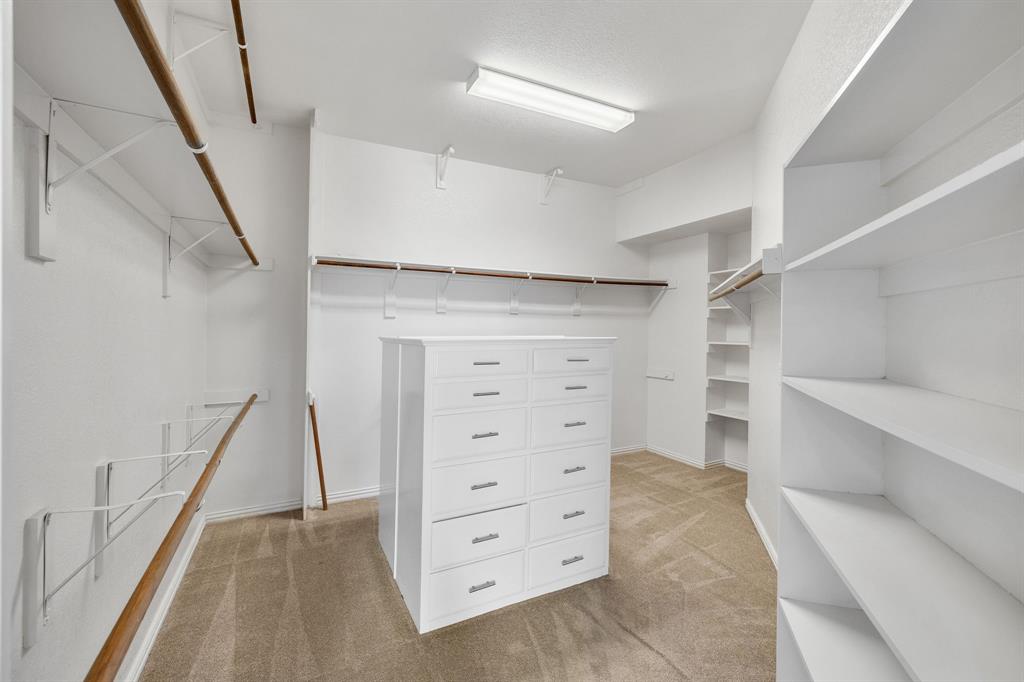 4512 Banyon Lane Dallas, TX 75287 - Photo 28 of 40 4512 Banyan Ln-Large primary closet, two tiered set up with wonderful drawer storage by Fang Underhill.
