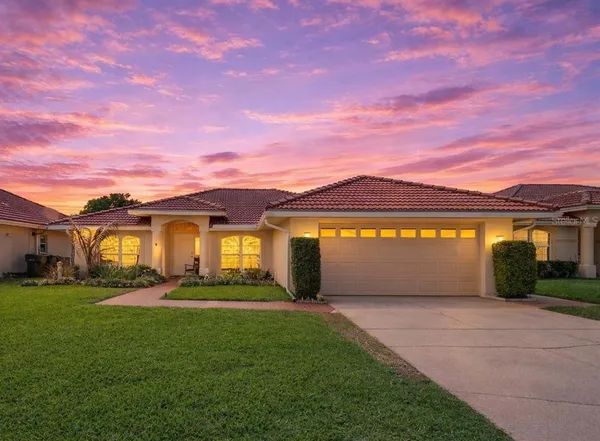 a front view of a house with a garden and yard