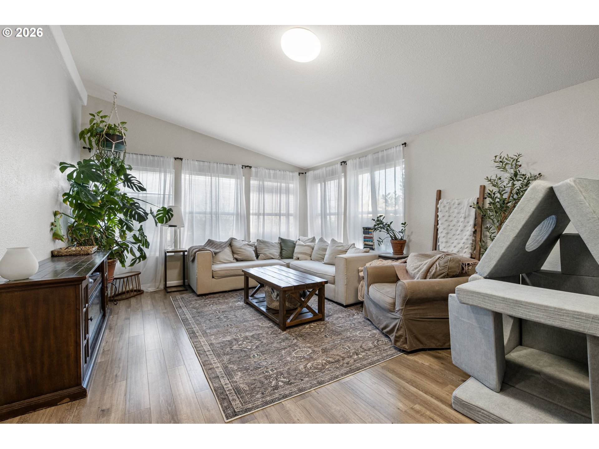 83149 Mickelson Road Creswell, OR 97426 - Photo 13 of 34 a living room with furniture a potted plant and a fireplace