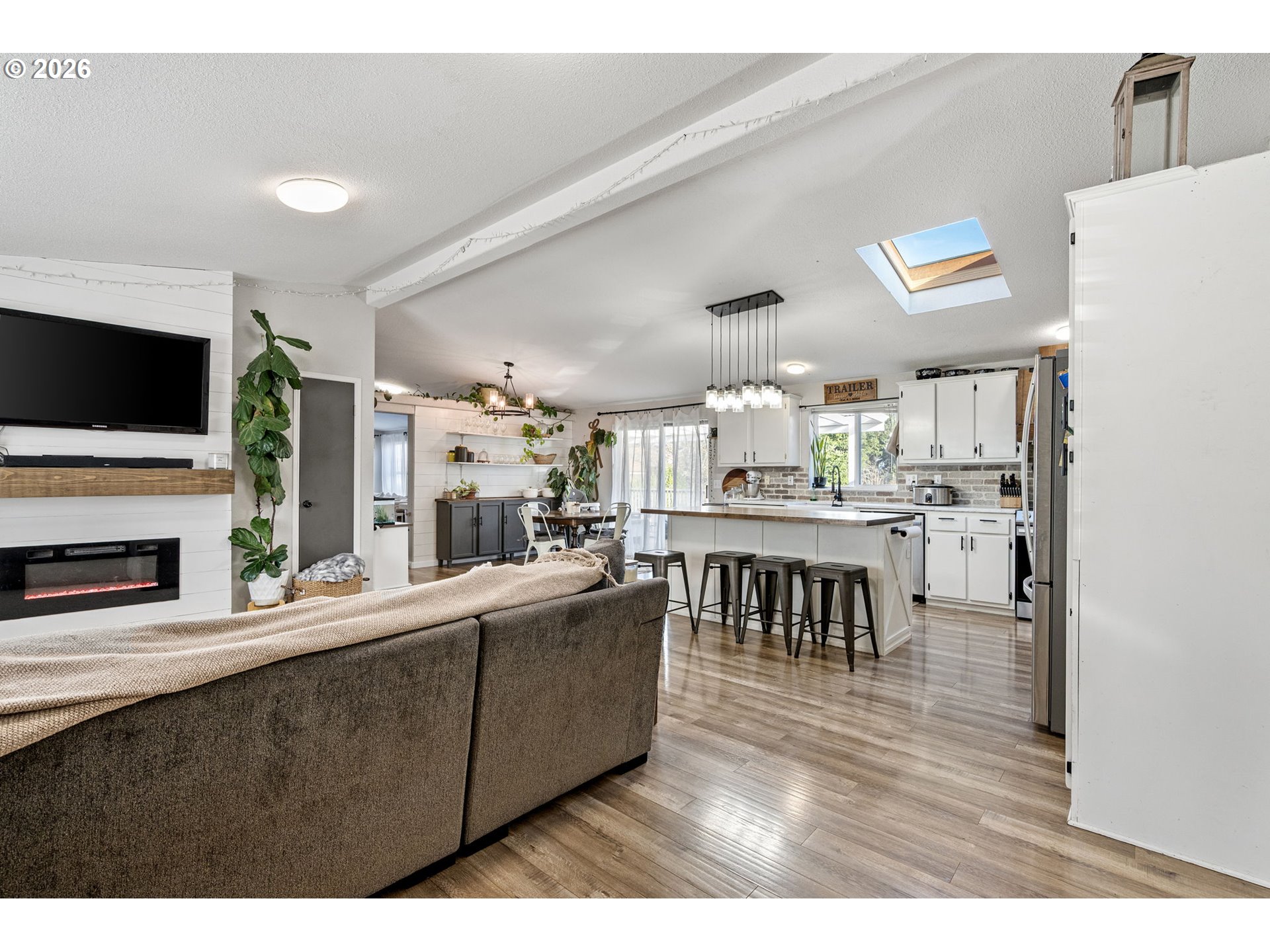 83149 Mickelson Road Creswell, OR 97426 - Photo 2 of 34 a living room with stainless steel appliances kitchen island furniture and a flat screen tv