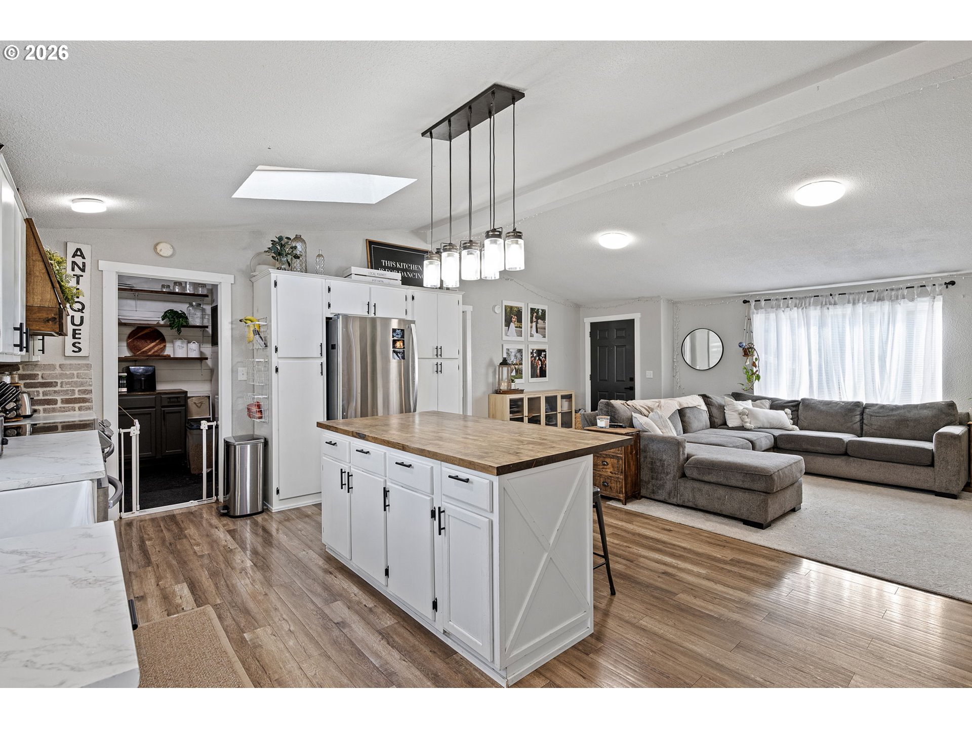 83149 Mickelson Road Creswell, OR 97426 - Photo 4 of 34 a living room with furniture a dining table wooden floor and a chandelier