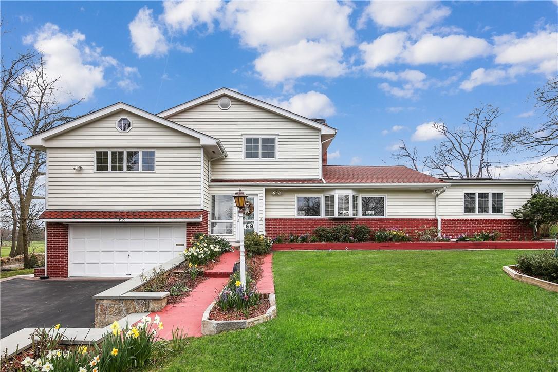 a front view of house with yard and green space
