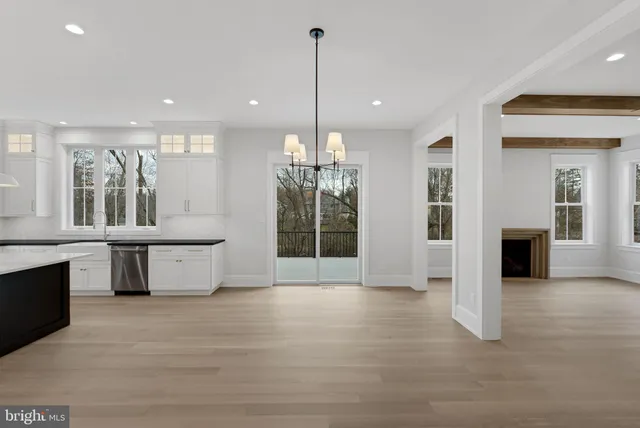 a view of a kitchen with granite countertop a stove and a floor to ceiling window