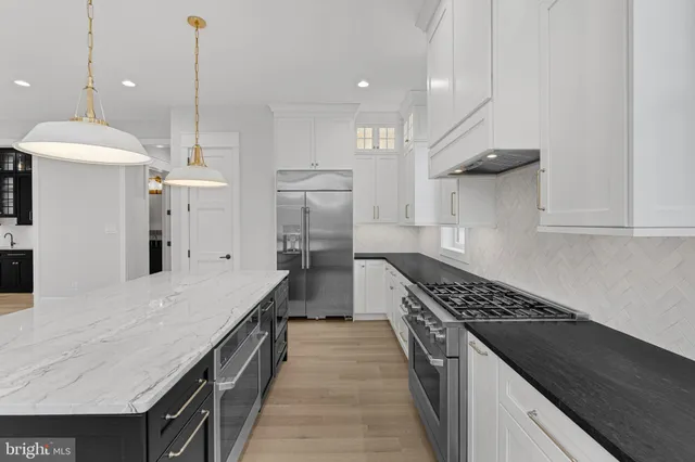 a kitchen with stainless steel appliances a sink stove and refrigerator