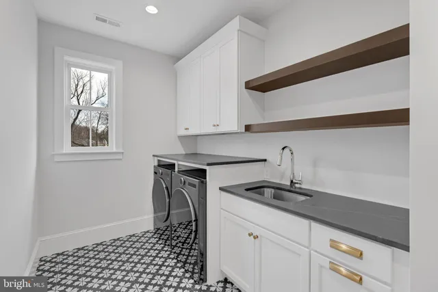 a kitchen with a sink a stove and cabinets