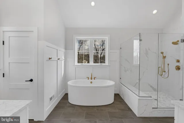 a white bath tub sitting next to a white sink