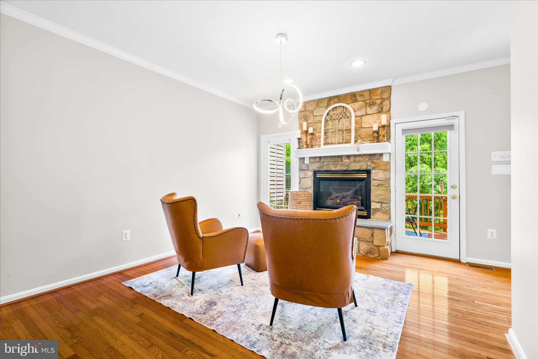 2442 Rippling Brook Road Frederick, MD 21701 - Photo 23 of 85 a living room with furniture and a fireplace