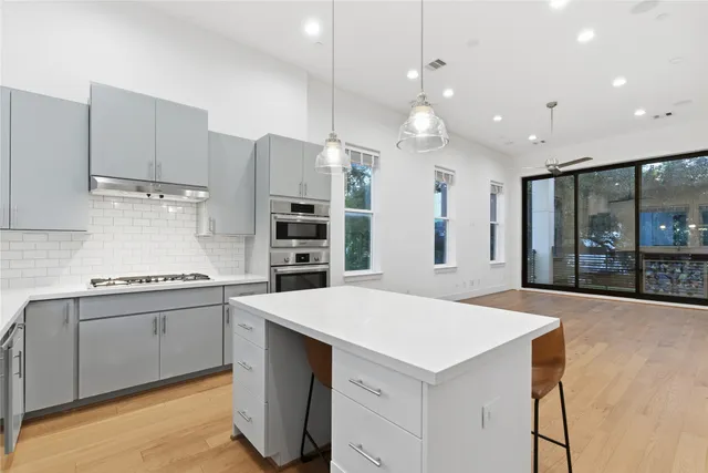 a kitchen with a stove a refrigerator and a sink