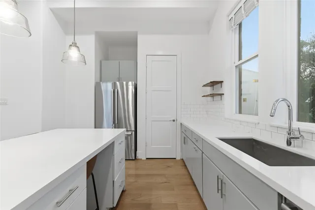 a kitchen with a sink and refrigerator