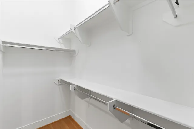 an empty room with wooden floor and white doors